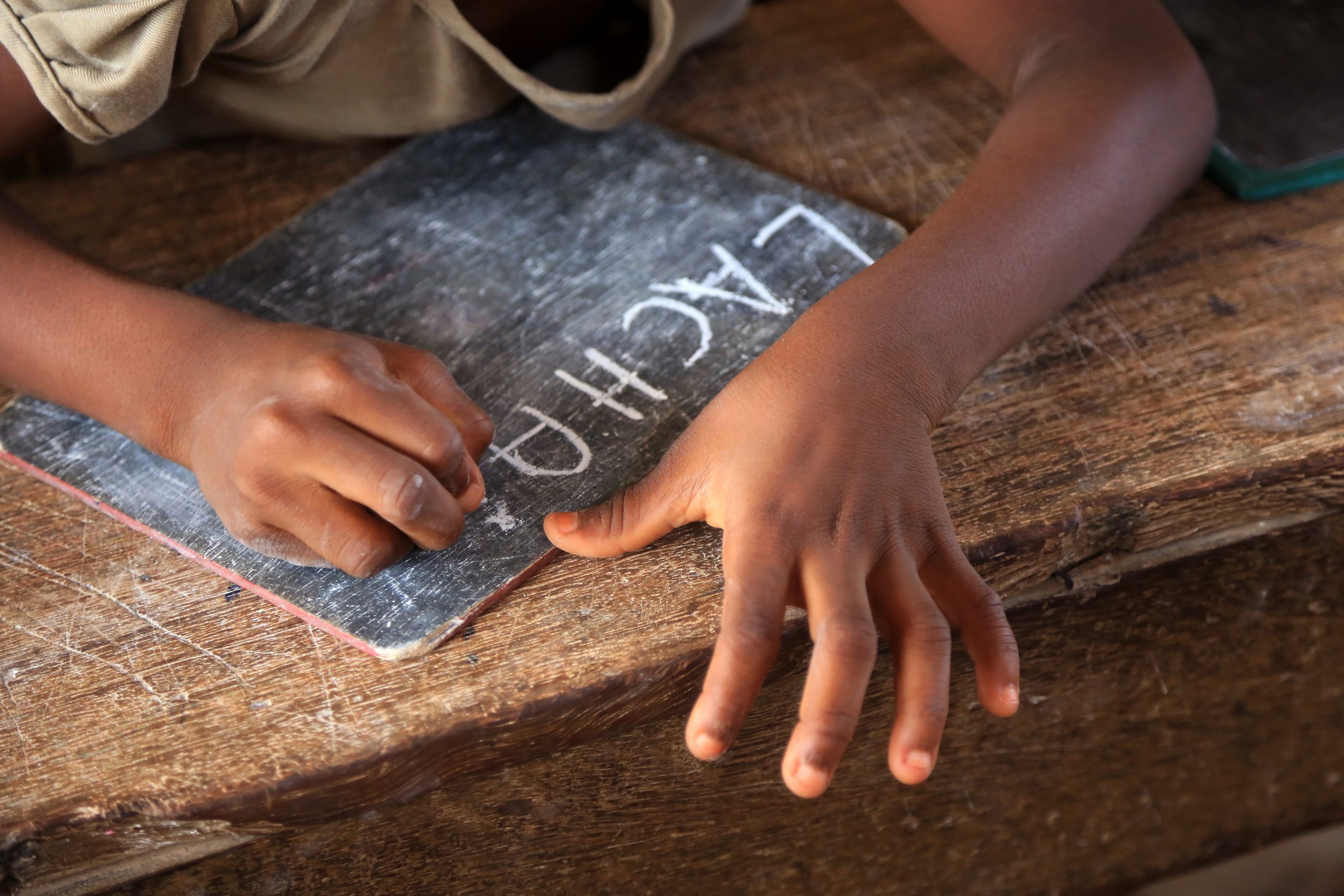 West Africa. Togo. Lome. 01/23/2014. This colorful image depicts a primary school student writing with chalk on a blackboard.